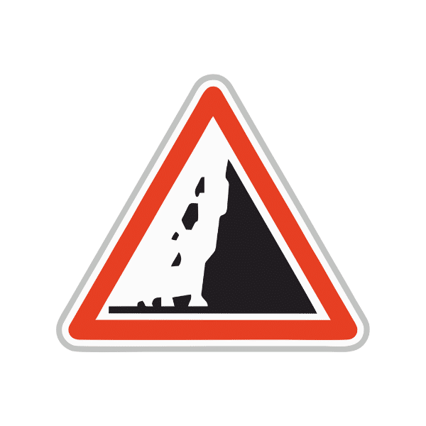 Panneau de danger risque de chute de pierres sur la route.